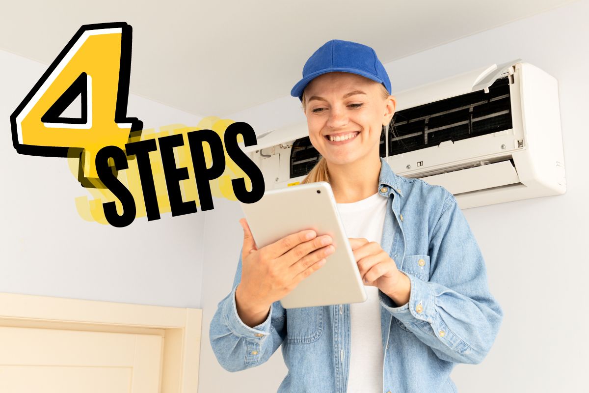 a female hvac technician in a blue hat looking at a report with a mini split heat pump installed on the wall behind her
