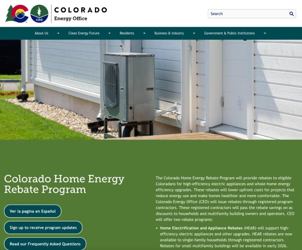 A picture of a heat pump in the grass of a Colorado home on the front page of the Colorado Energy Office HEAR website page