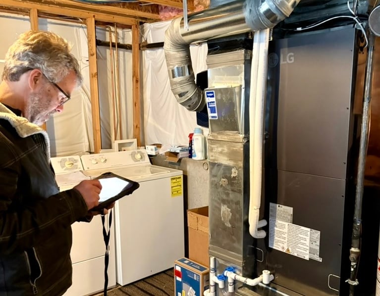 the hear inspector checking our lg red heat pump work in the basement
