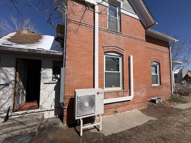 heat pump exterior of the house with brick from the side