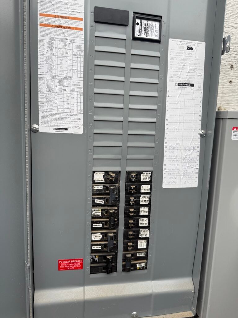 chris's electrical panel with the door open showing open breaker slots for the heat pump