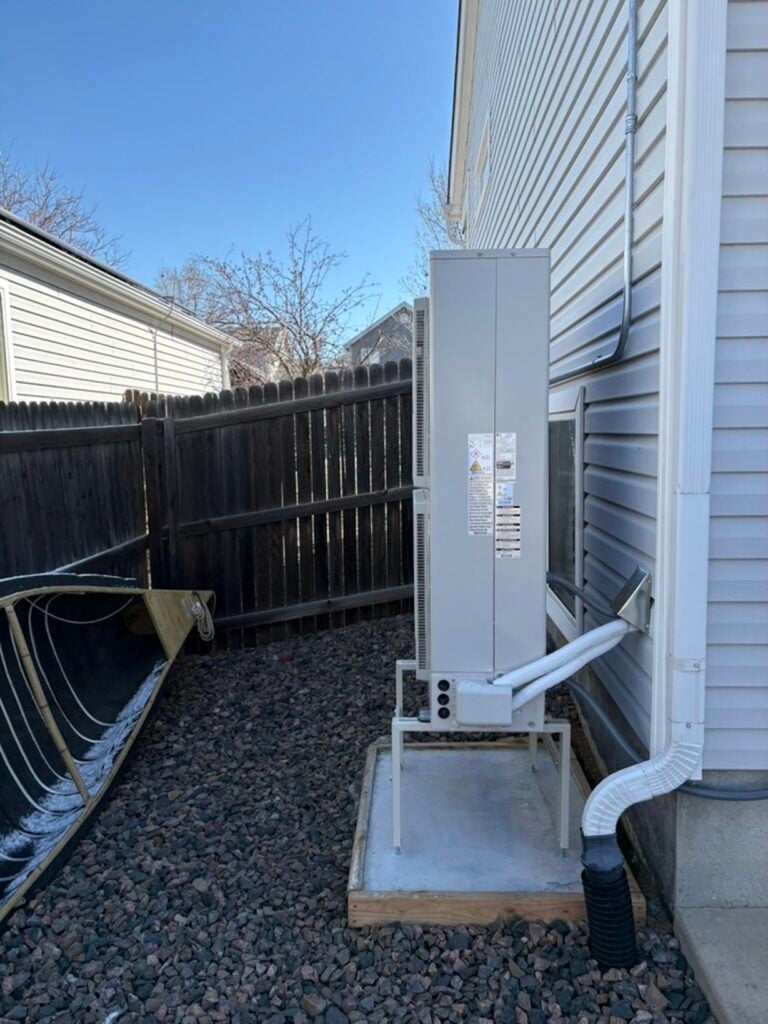 side view of the new lg red cold climate heat pump condenser on concrete slab
