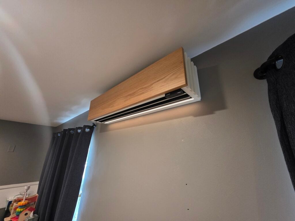 Close-up of a modern wood-finish Quilt ductless heat pump indoor unit