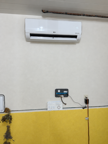 LG ductless mini-split indoor head mounted on a wall above a thermostat in a Lone Tree, CO home