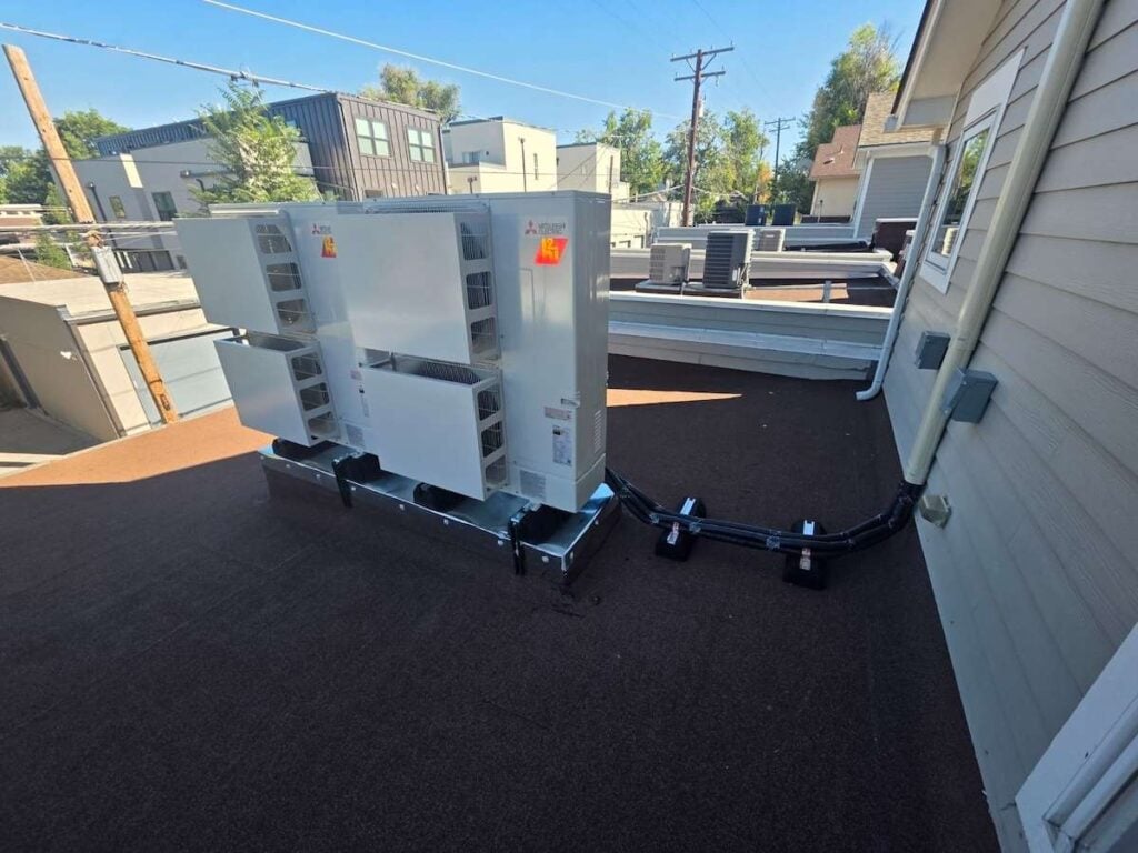 A dual-system Mitsubishi heat pump system installed in Cherry Creek Denver. This was roof mounted with some wind baffles installed.