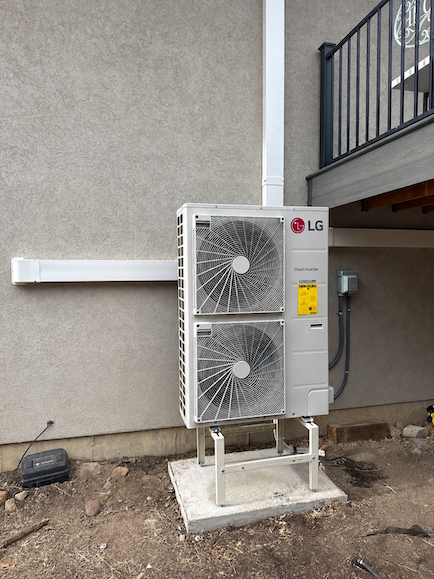 Outdoor LG multi-zone heat pump condenser mounted on a raised stand and concrete pad beside a Lone Tree, CO home