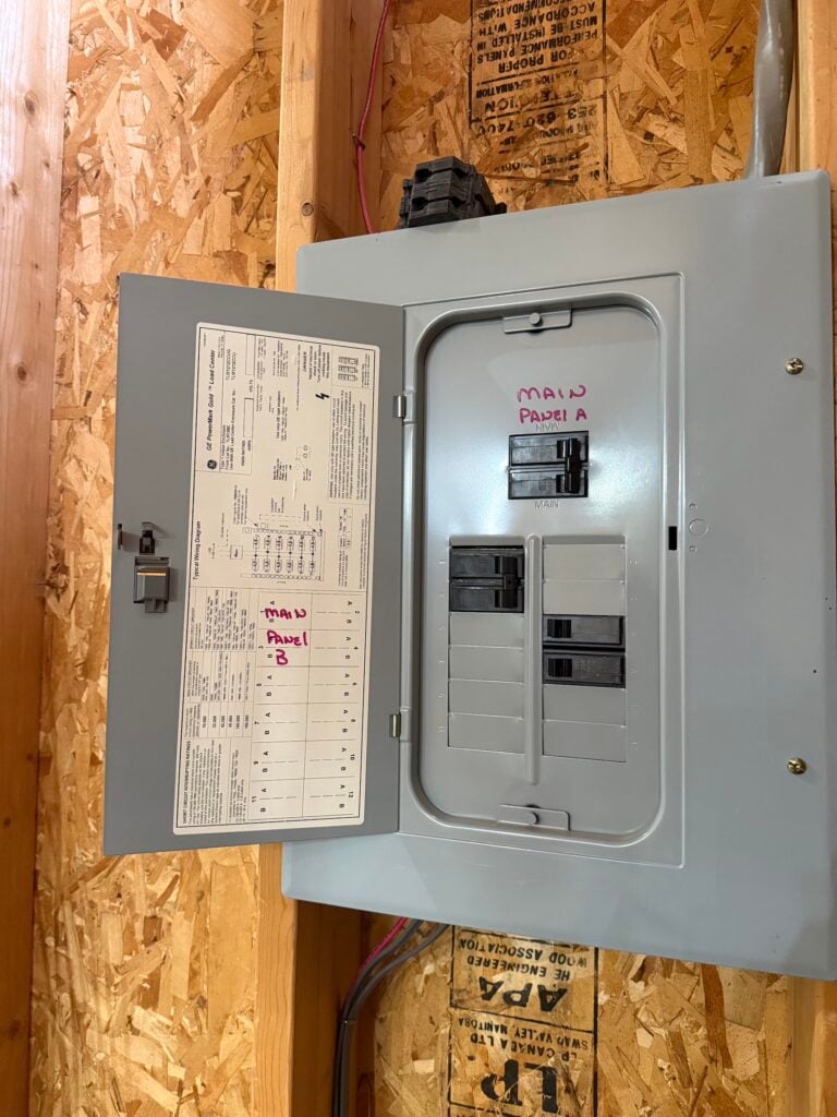 Open electrical load center panel in a Lone Tree, CO home before heat pump installation