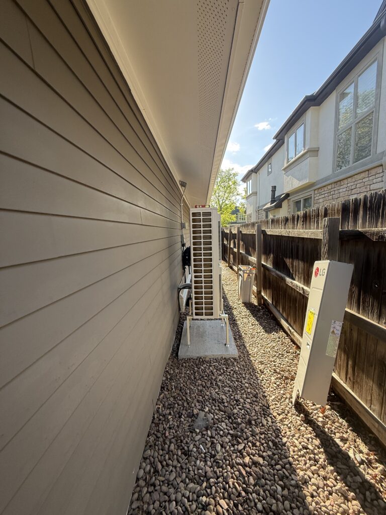 Our LG RED outdoor unit installed on a concrete pad next to the house in University Park, Denver CO