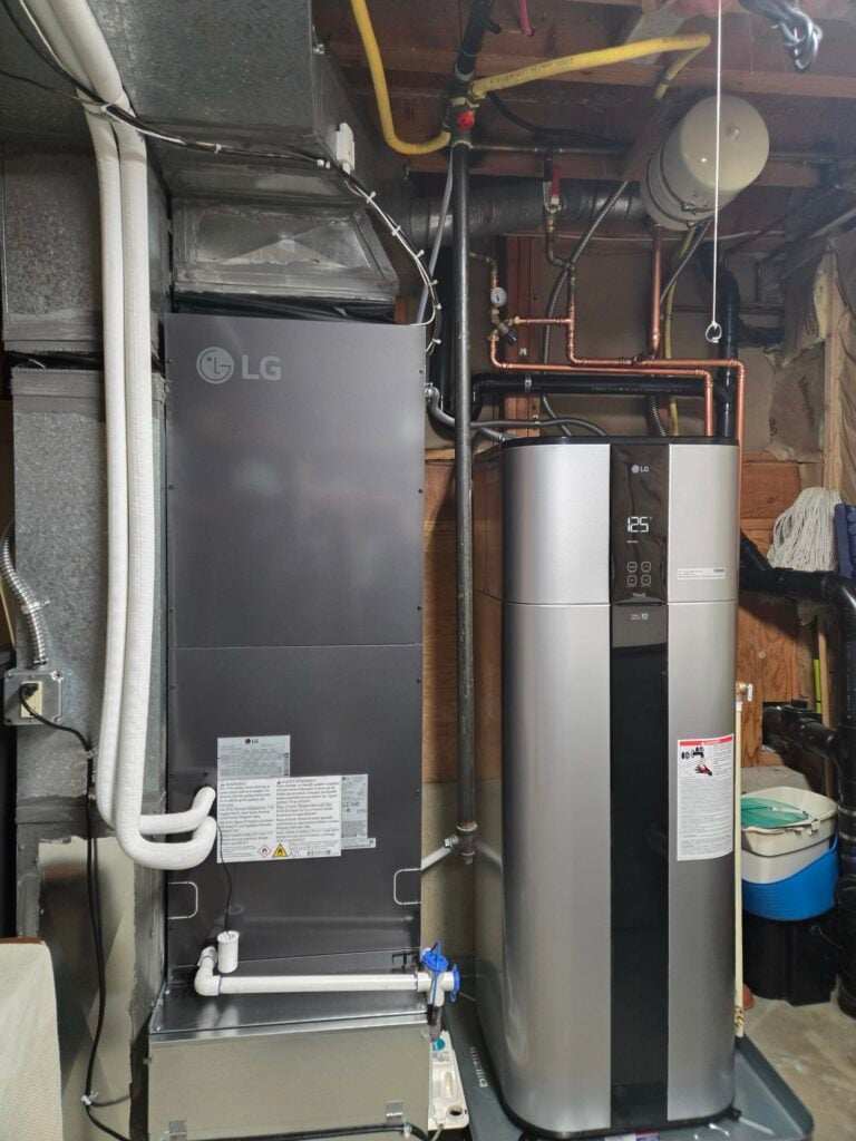 An LG RED air handler for our ducted heat pump customer's home, sitting next to an LG heat pump water heater in the basement