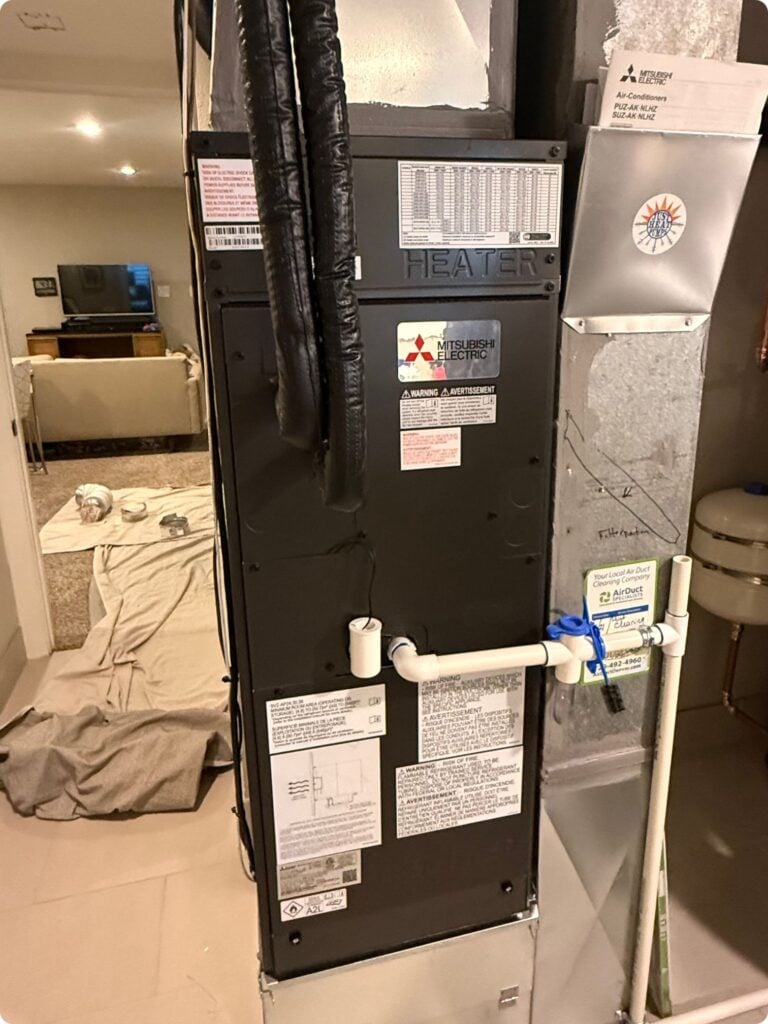 out mitsubishi h2i heat pump ducted air handler installed in a denver basement