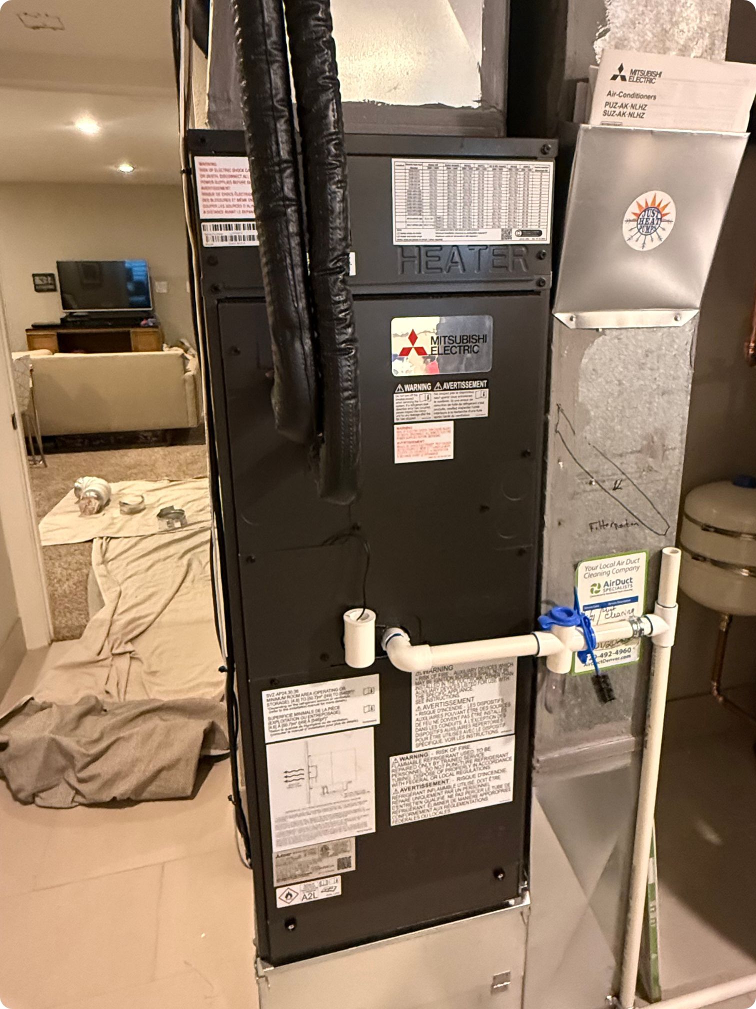 out mitsubishi h2i heat pump ducted air handler installed in a denver basement